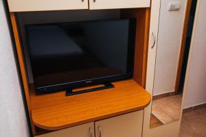 a flat screen tv sitting in a cabinet at Jezero Laminci in Bosanska Gradiška