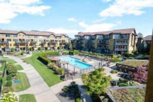 an aerial view of an apartment complex with a swimming pool at The Beach House at Barona Beach 4301 in West Kelowna