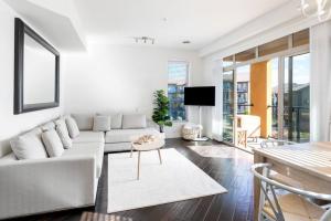 a living room with a white couch and a table at The Beach House at Barona Beach 4301 in West Kelowna