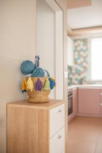 a basket of yarn sitting on a table in a kitchen at ROZÉ BLUE DESIGN APARTMENTS in Csopak