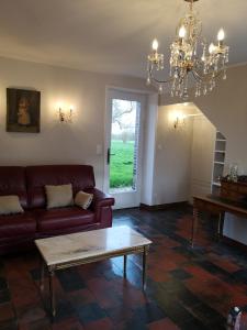 a living room with a couch and a table at LEBAS-LADIN in Lison