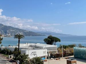 a large white building with a view of the water at Magnifique T4 face à la mer, vue panoramique 180° in Roquebrune-Cap-Martin