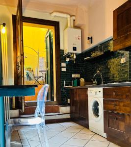 a kitchen with a washer and a washing machine at Piazza Verdi Apartment in Bologna