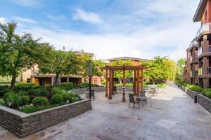 a patio with a gazebo in a courtyard at Upper Floor w Courtyard View 550 in Kelowna