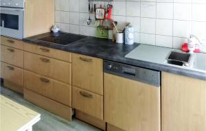 a kitchen with a sink and a stove top oven at Cozy Home In Olib With Kitchen in Olib