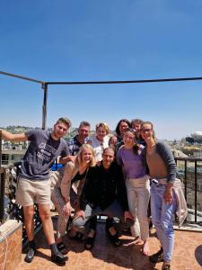 a group of people posing for a picture on a roof at New Citadel Hostel in Jerusalem