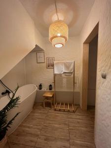 a bathroom with a large bath tub and a sink at Apartamenty Prosta - Podmurna in Toruń