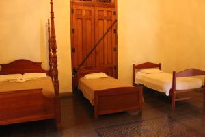 a room with two twin beds and a chair at Backpackers Inn in Granada