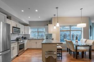 a kitchen with a table and a dining room at Fabulous Condo at Five Star Resort 209 in West Kelowna