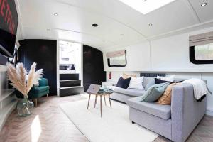 a living room with a couch and a table at The Vätten Hüs A Luxury/VIP boat in Manchester