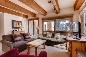 a living room with a couch and a table at 2 Br- Amazing View Of Mt Crested Butte Condo in Crested Butte