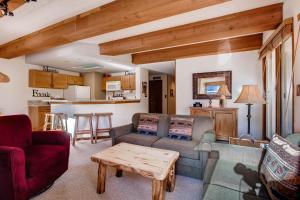 a living room with two couches and a table at 2 Br- Amazing View Of Mt Crested Butte Condo in Crested Butte