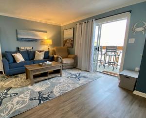 a living room with a couch and a table at Marylander Condominiums, 90 steps from the beach in Ocean City