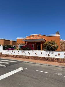 a building on the side of a city street at Casa Piedra, Luxury Family Front Line Golf, Hot Tub,Pool Table, 8 pers, Caleta de Fuste in Caleta De Fuste