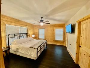 a bedroom with a bed and a flat screen tv at Cabin at Chitt's Creek in Emory