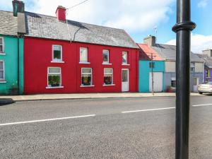 a red building on the side of a street at Shoemaker's Rest 