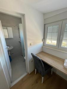 a dining room with a wooden table and a bathroom at Pansion Turudić in Međugorje +46 photos