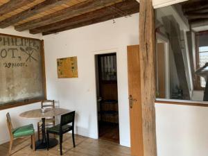 a dining room with a table and chairs in a room at Aube berges de Troyes in Troyes