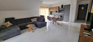 a living room with a couch and a table at Apartmaji Živa in Gornja Radgona