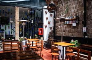 a restaurant with wooden tables and chairs in a room at Intro Hostels Cusco in Cusco