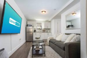 a living room with a couch and a flat screen tv at Lovely Apartment Near Brickell 1 in Miami