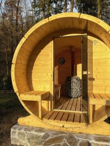 a wooden sauna with a large wooden circle in the middle at Chata Roklinka in Benešov