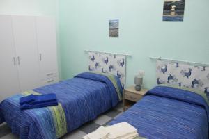 A bed or beds in a room at Casa Vacanze Nonna Franca