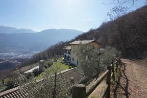 a house on the side of a hill with a fence at Agritur Maso Carpenè in Rovereto