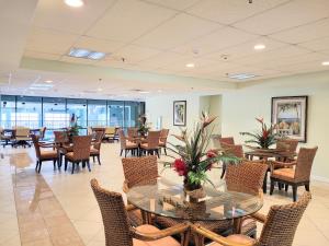 a dining room with tables and chairs in a building at Makai 403 in Ocean City