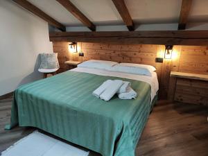 a bedroom with a bed with two towels on it at A casa da Elide in Aymavilles