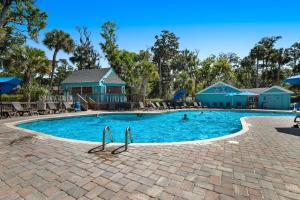 a swimming pool at a resort with people in it at Egrets Pointe, Unit 492 in Edisto Island