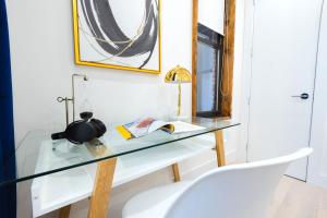 a glass desk with a chair and a mirror at 317-3D I NEW Modern 1BR W&D Walk to Central Park in New York