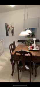 a dining room table with chairs and aendant light at Grandma’s stone-house in Amfilochía