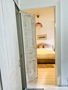 an open door to a bedroom with a bed at Grandma’s stone-house in Amfilochia