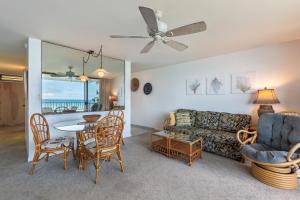 a living room with a couch and a table and chairs at Paki Maui Condos in Honokowai