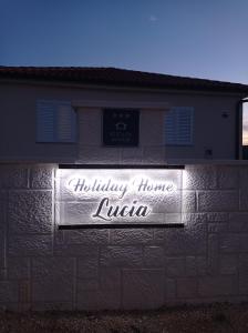 a sign on the side of a building at Holiday Home Lucia in Lozovac