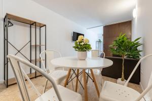 ein Esszimmer mit einem weißen Tisch und Stühlen in der Unterkunft Apartament Confort en Barri Port Maritim in Tarragona