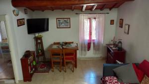 a living room with a table and a television at La Dimora del 1700 in Tivoli