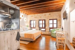 a kitchen and a bedroom with a bed in a room at Mandorla Apartments in Rhodes Town