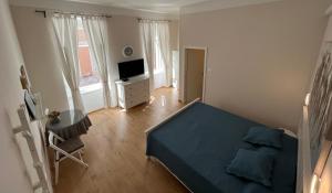 a bedroom with a blue bed and a television at Apartment Check in in Pula