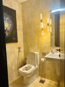 a bathroom with a toilet and a sink at 1-Berdroom Apartment Rental Unit With Pool in Dubai Land Residence Complex in Dubai