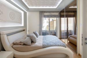 a bedroom with a bed in a room with a window at De President Suite, DeMaNi President Suites in Sitia