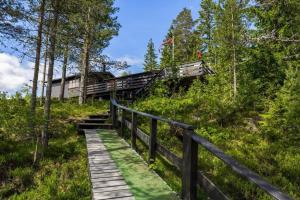 a wooden boardwalk leading down a hill with a train on it at Bromlebu in Notodden