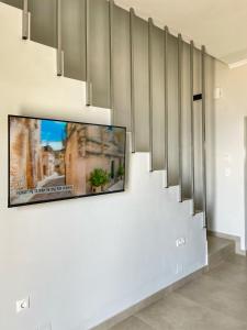 a tv hanging on a wall in a living room at Selene houses in Athanion