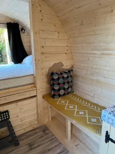 a small wooden cabin with a bed in it at Logement insolite in Commequiers