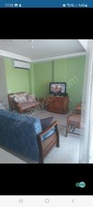 a room with two beds and a tv in it at Semiramis Garden in Milas