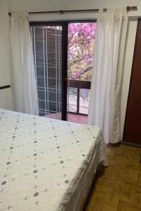 a bedroom with a bed and a large window at Armonía 1 in Córdoba