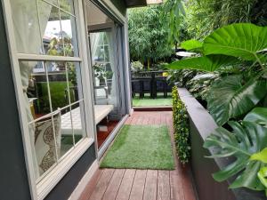 an open door to a porch with plants at Bamboo House, Close to the City & Airport & Train station and Brighton Le Sands Beach in Sydney