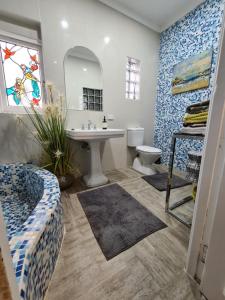 a bathroom with a sink and a toilet and a mirror at Bamboo House, Close to the City & Airport & Train station and Brighton Le Sands Beach in Sydney