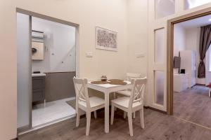 Un comedor con una mesa y sillas blancas. en Goldcentral Apartment Comfort, en Budapest